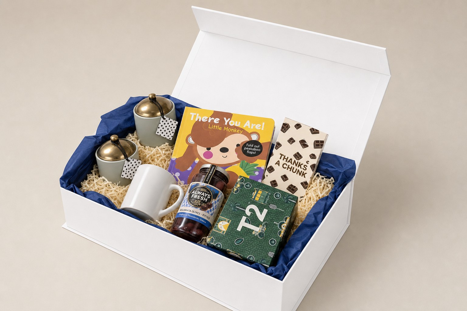 A hamper image generated inside Proposal Studio, showing the chosen box, blue tissue, shredded fill and the selected products